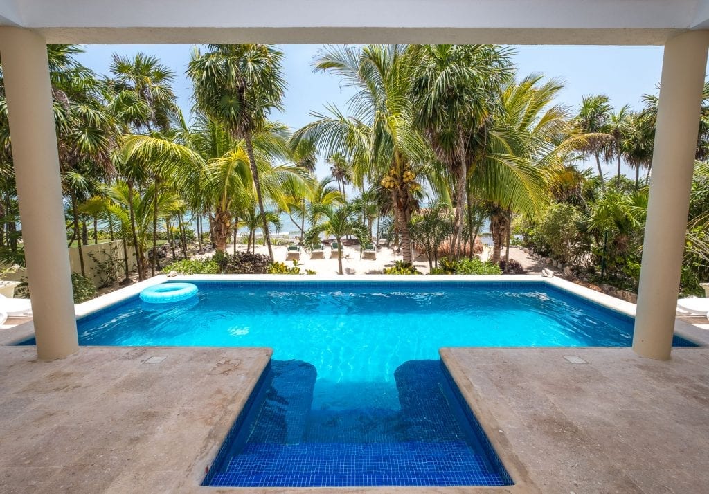 Villa Luminosa from the loggia over the pool to the beach light — Tulum, Mexico