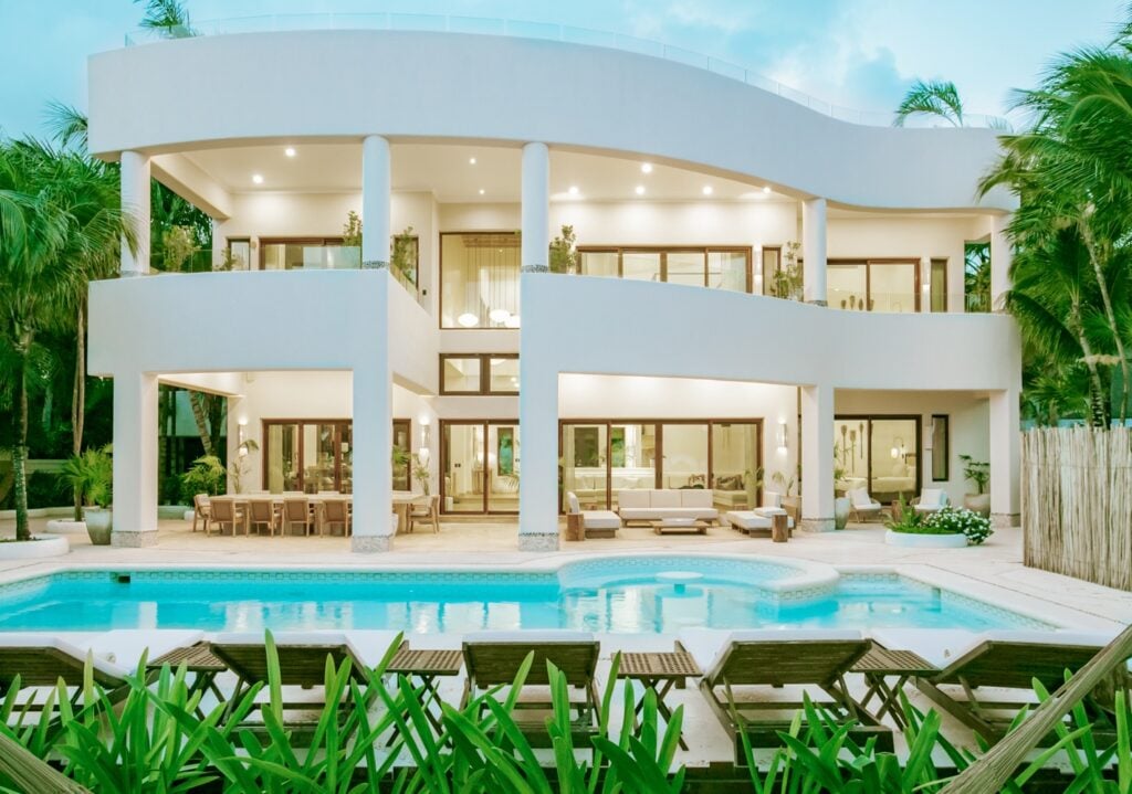 Cenote del Mar two-story villa facade with pool and sun loungers — Tulum, Mexico