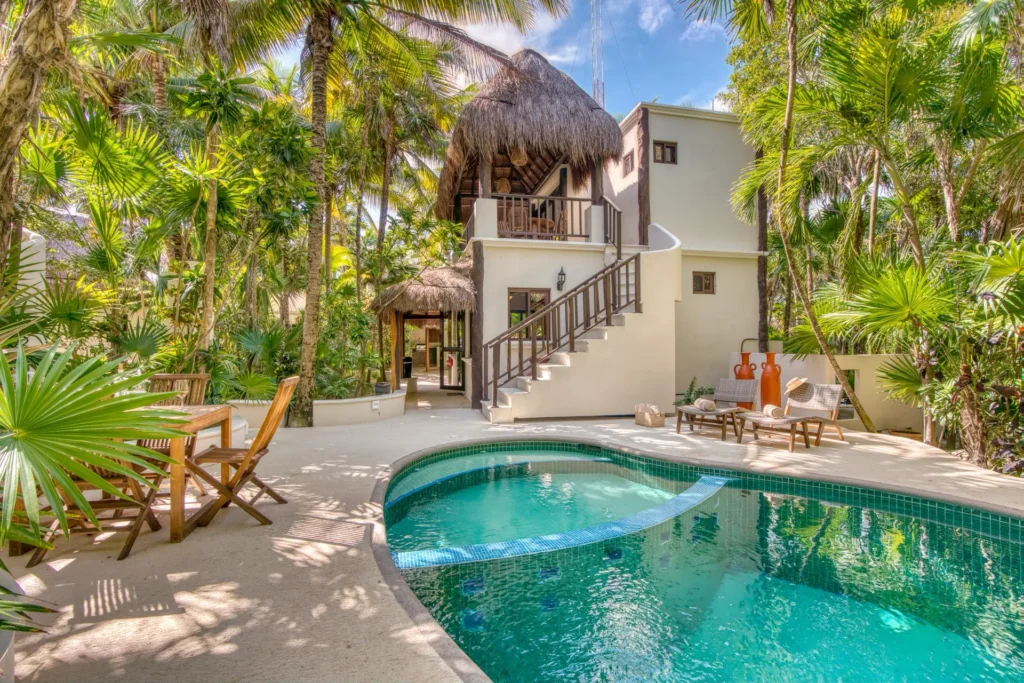 Casa Corazon Estate two-story villa exterior with palapa roof staircase and pool — Soliman Bay Tulum