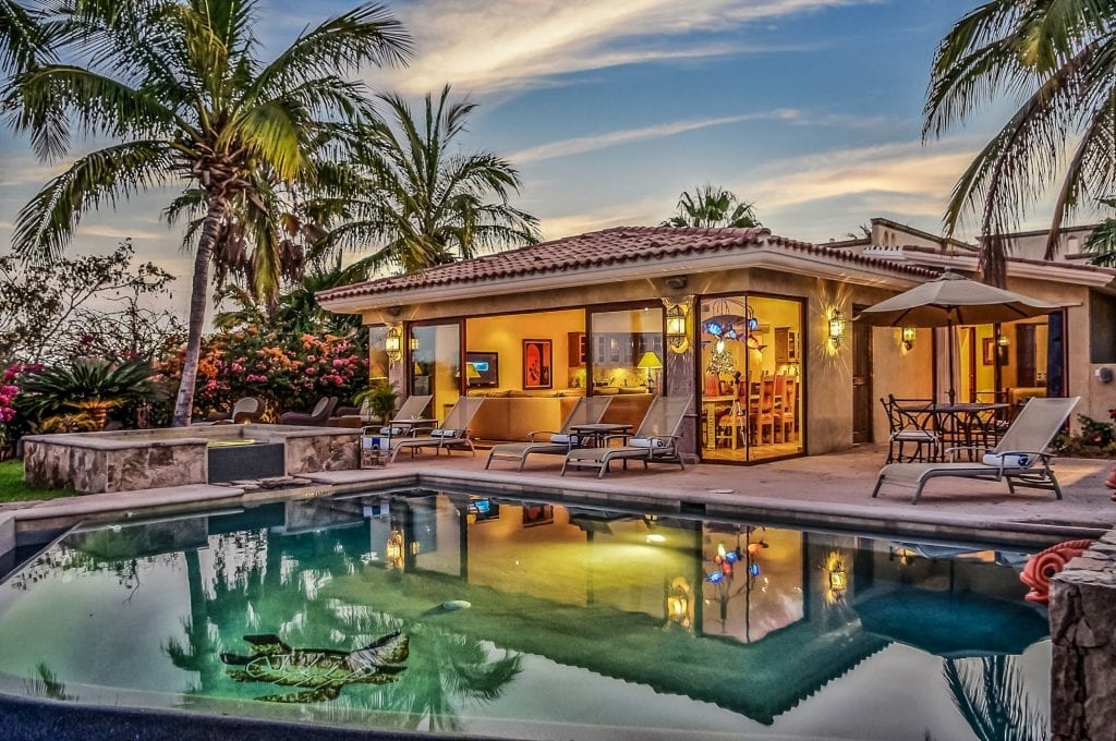 Casa Tortuga Cabo del Sol villa and pool illuminated at dusk with palms — Los Cabos, Mexico