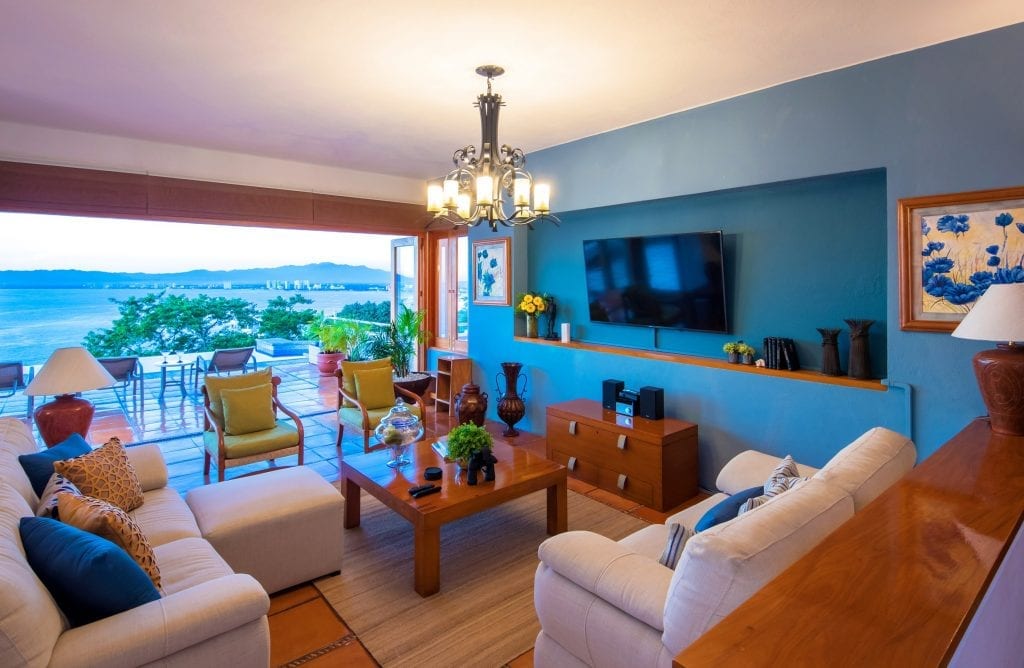 Casa La Palma living room with TV and bay-view terrace — Puerto Vallarta, Mexico