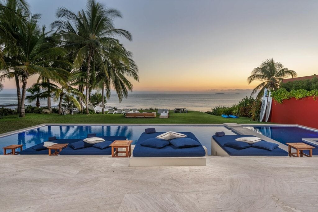 Villa Pacifica sunken daybed lounge beside the pool at last light — Punta Mita, Mexico
