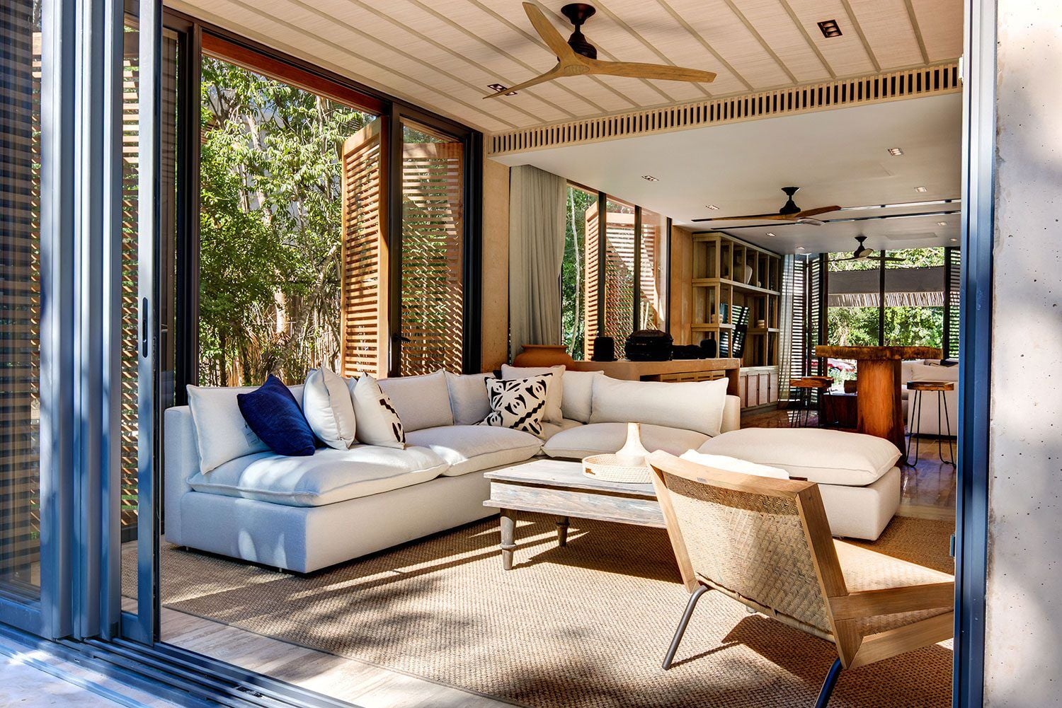 Palm Villa Experience living room with a sectional opening to the trees — Playa del Carmen, Mexico
