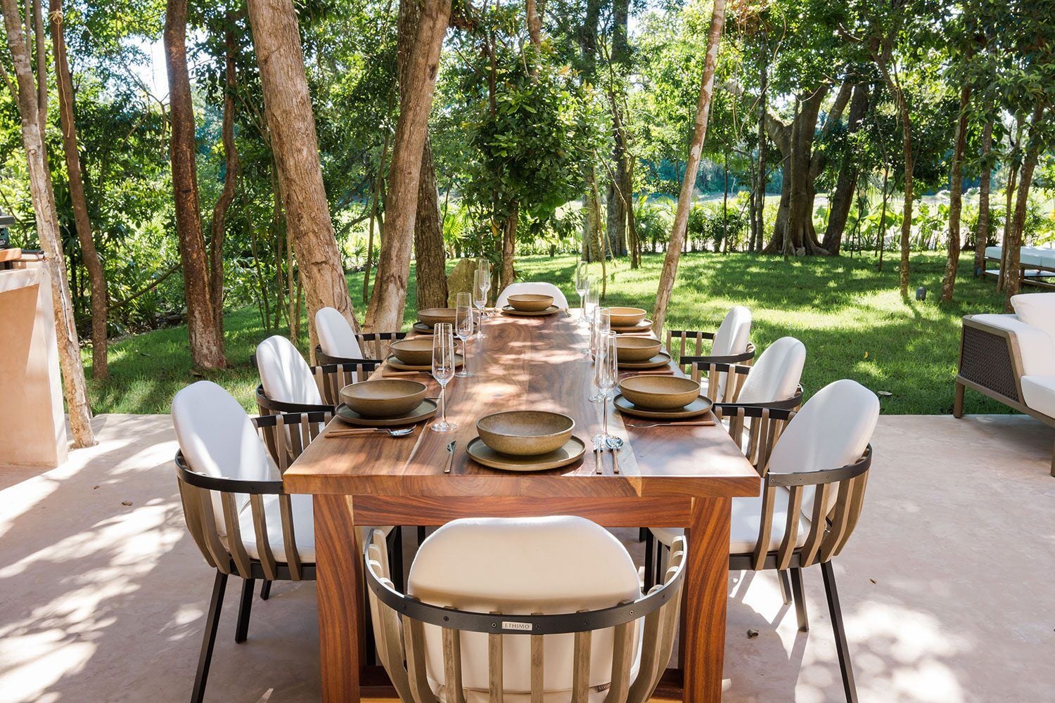 Palm Villa Experience terrace dining table set beneath shade trees — Playa del Carmen, Mexico