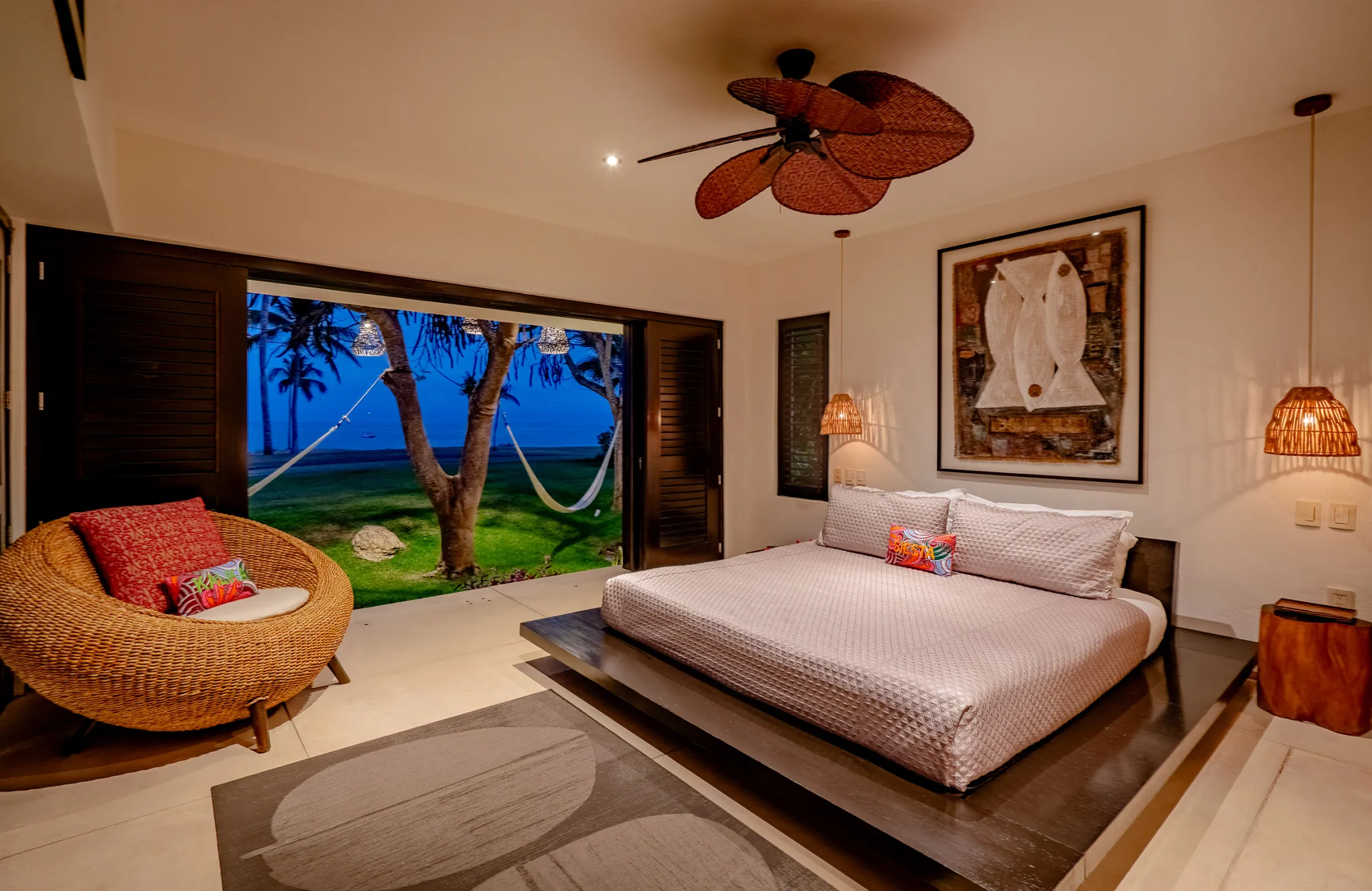 Casa Kalika bedroom with a platform bed and open doors to the lawn — Punta Mita Nayarit, Mexico