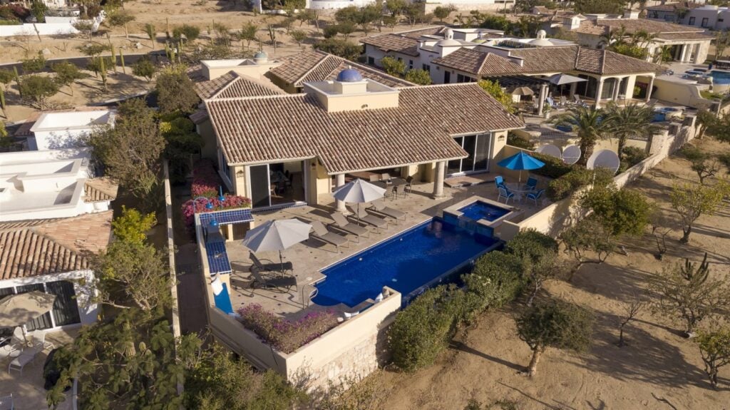 Villa Stamm aerial view of the villa, blue pool, umbrellas and dry hillside — Los Cabos, Mexico