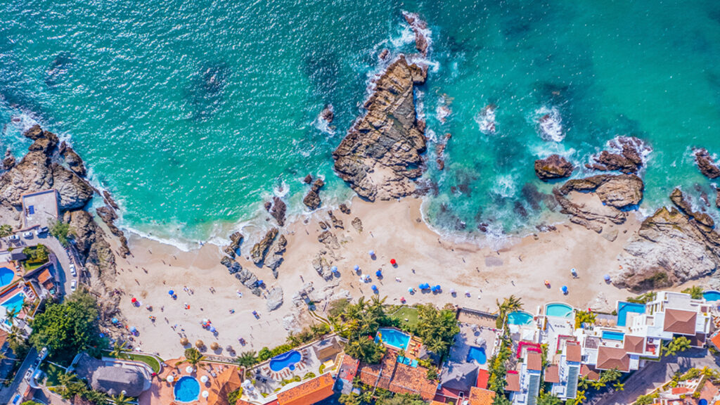 Aerial view of a row of villas at Conchas Chinas Beach in Puerto Vallarta, Mexico.