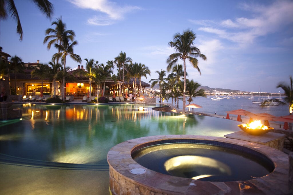 Hacienda Beach Villa view of a round spa and illuminated pool at dusk — Los Cabos, Mexico
