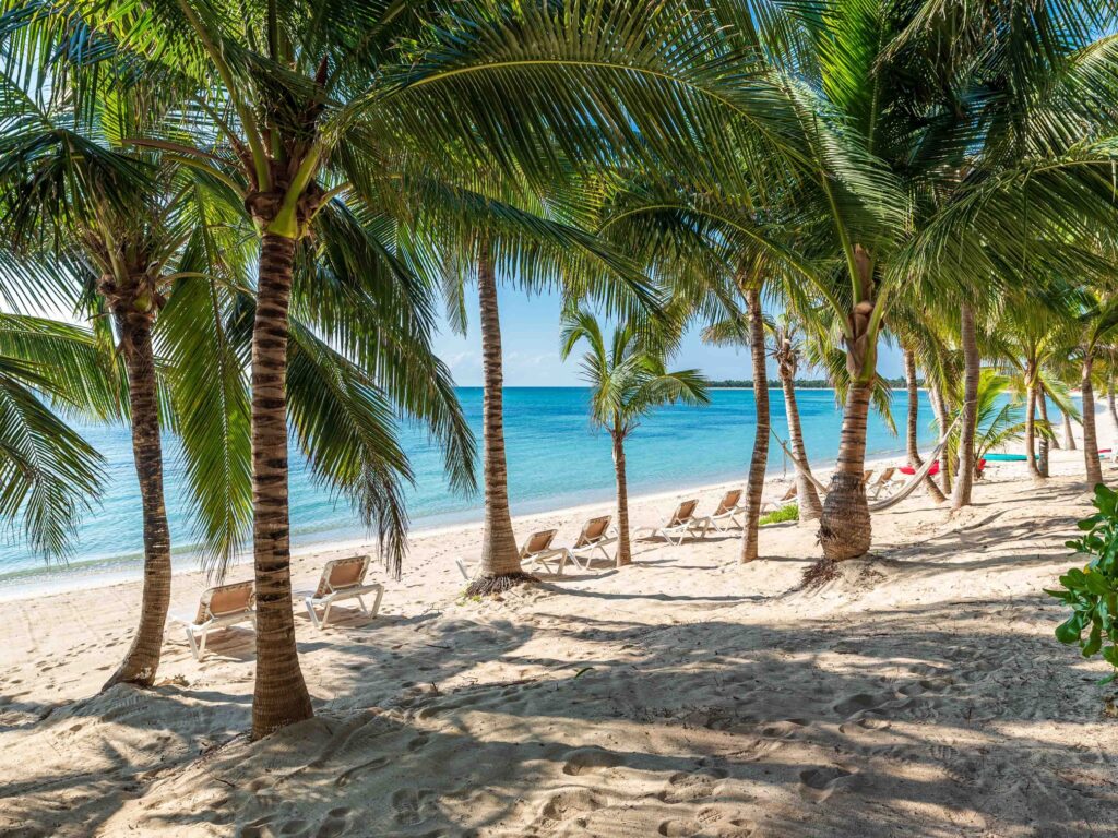 Picturesque view of Tankah Bay's sandy beach and azure waters.