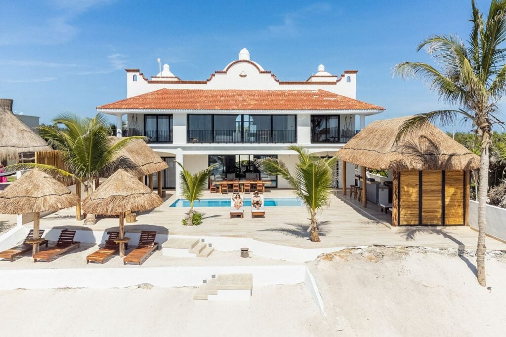 Villa Bella Vita aerial view of villa with palapas and beachfront pool — Tulum, Mexico