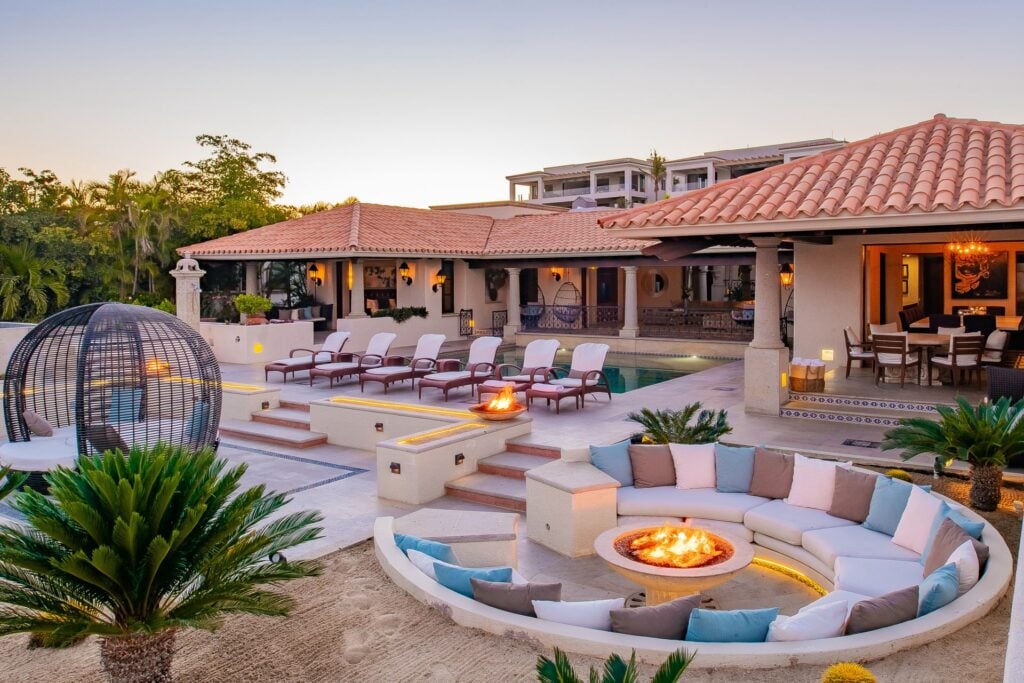 Casa Brooks sunken circular fire pit with cushioned seating at dusk — Los Cabos, Mexico