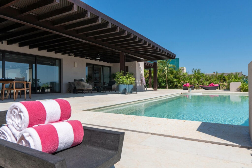 Villa Brisa Marina sun lounger with rolled towels at the pool edge — Punta Mita Nayarit, Mexico