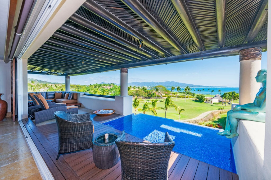 PH Vista el Encanto terrace seating beside a small pool with a golf course view — Punta Mita Nayarit, Mexico