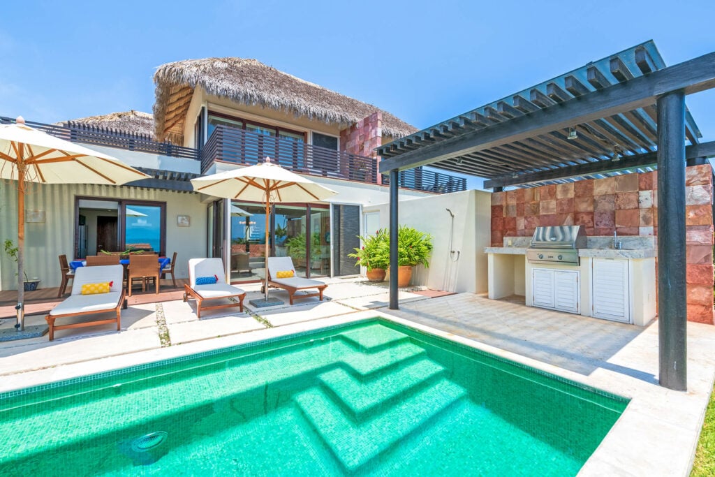 Villa Perla pool steps facing the exterior, loungers and built-in grill — Punta Mita Nayarit, Mexico