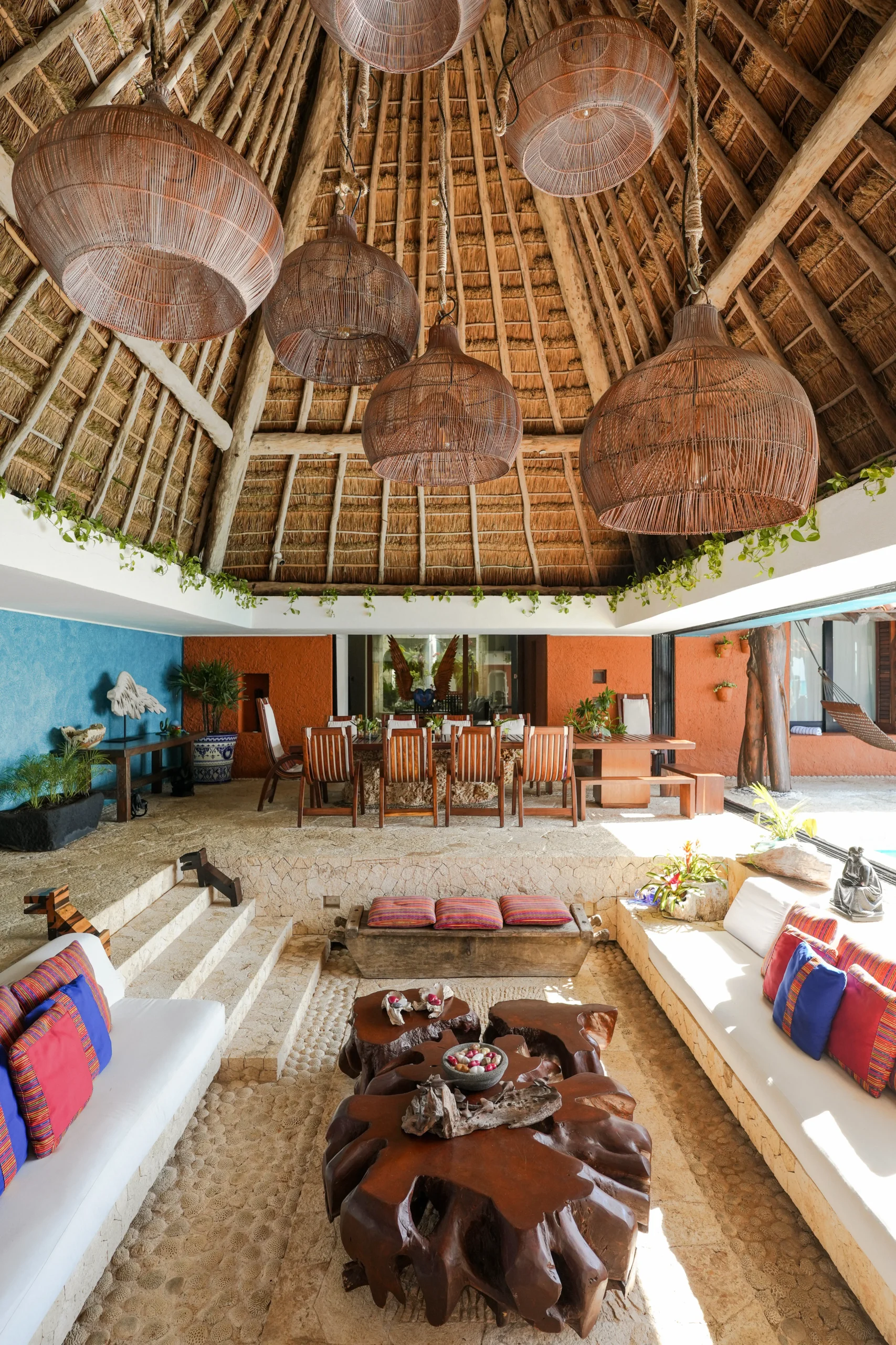 Casa Corazon dining area under thatched palapa roof with wooden table — Playa del Carmen, Mexico