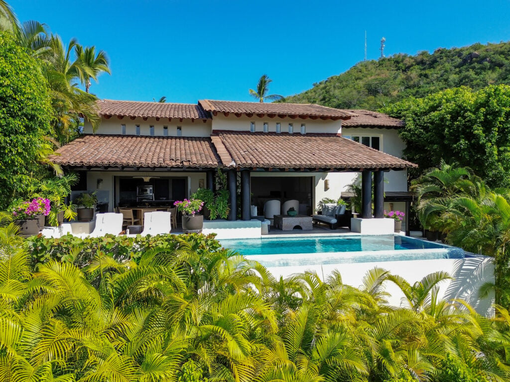 The Four Seasons Presidential Villa exterior with tiled roofs and pool above dense palms — Punta Mita Nayarit, Mexico
