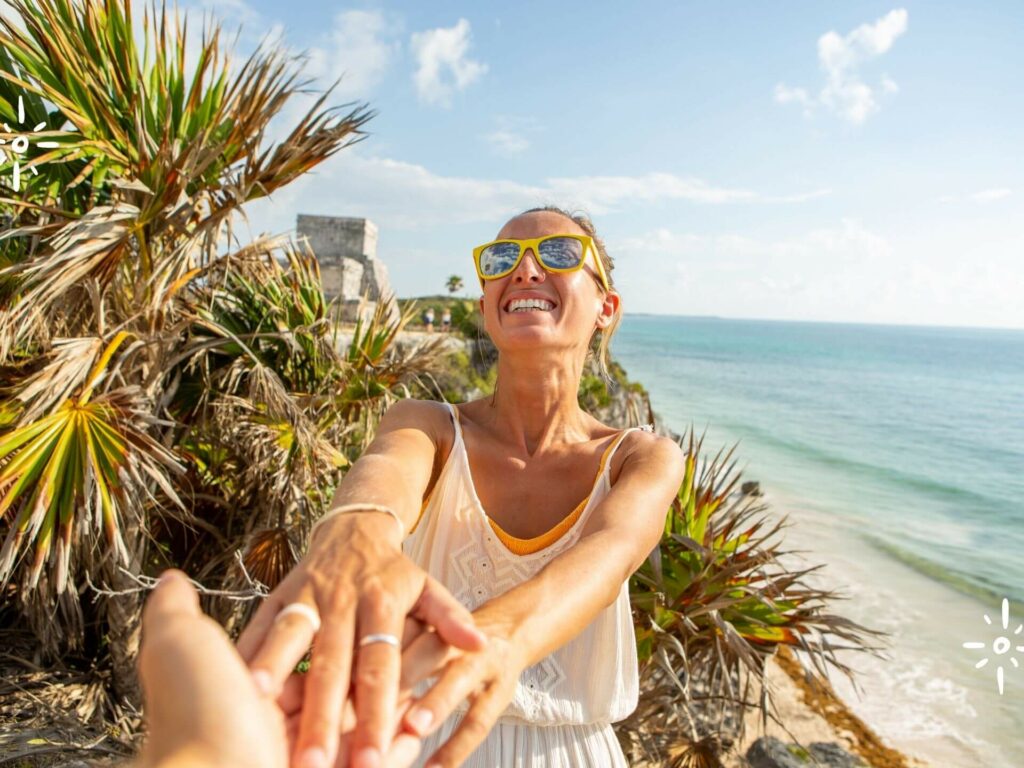 Group member joyfully participating in the Leadership Retreat Tulum with picturesque Caribbean Sea backdrop