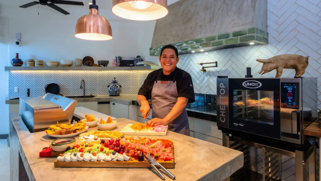 Chef preparing food in the modern kitchen of Las Villas PV.