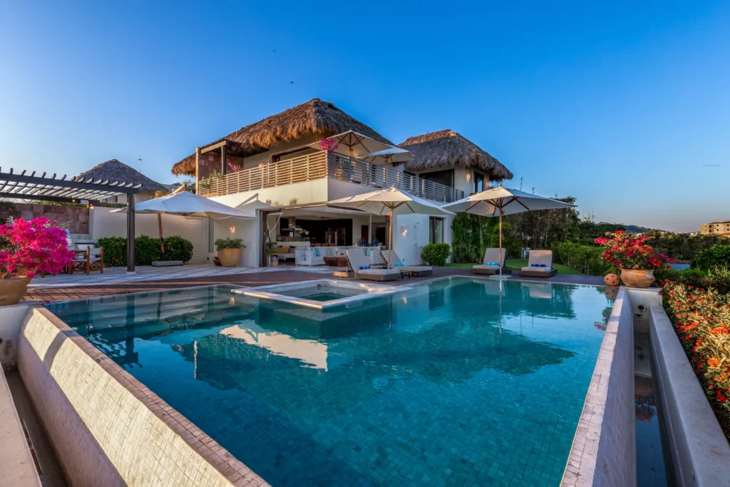 Casa de Las Aves - Casita Zen 14 blue pool with a square inset below the thatched exterior — Punta Mita Nayarit, Mexico