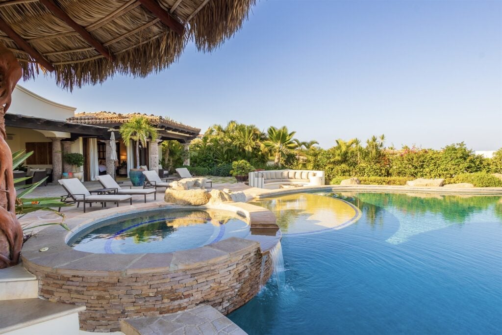 Casa Lomboy palapa beside the infinity pool and round spa with loungers — Los Cabos, Mexico