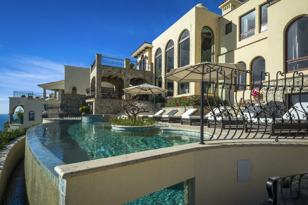 Casa Rio de Luna wraparound infinity pool below the terraced villa — Los Cabos, Mexico