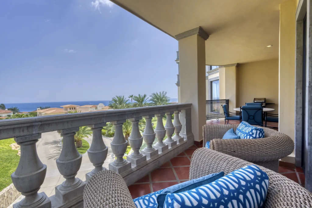 Condo Puerta del Sol B205 covered terrace with balustrade railing and lounge seating — Los Cabos, Mexico