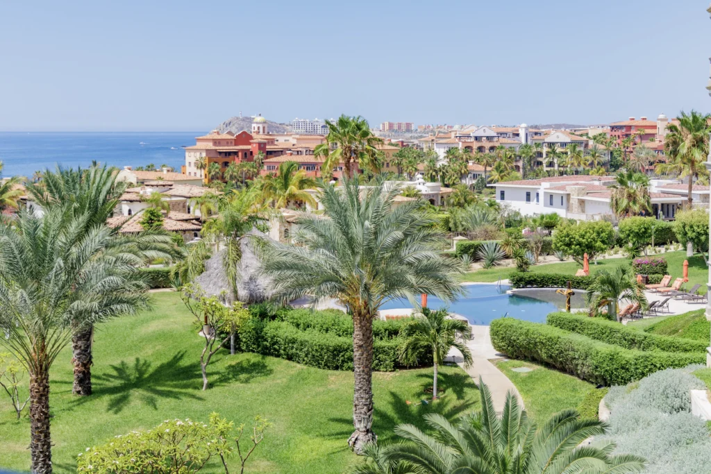 Condo Puerta del Sol C301 balcony view over the resort pool and gardens — Los Cabos, Mexico