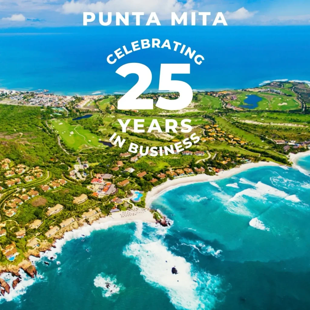 Aerial view of Punta Mita’s coastline with lush greenery, golf courses, and luxury homes, celebrating 25 years in business. The ocean waves crash against the shore, showcasing the stunning natural beauty of the destination.