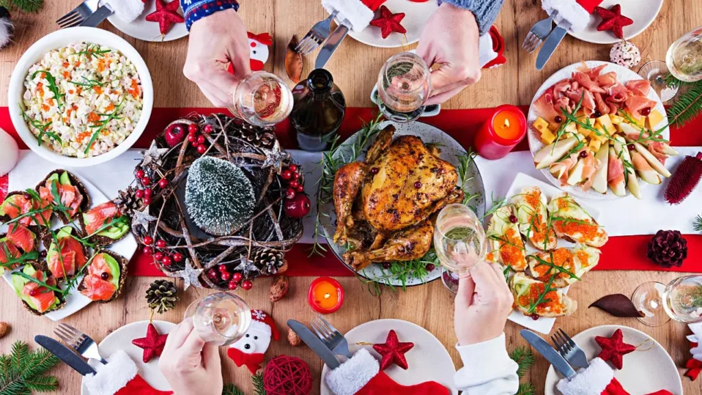 A festive dinner table in Punta Mita, Mexico: roasted chicken, appetizers, salads; four toasting amid Christmas decorations.