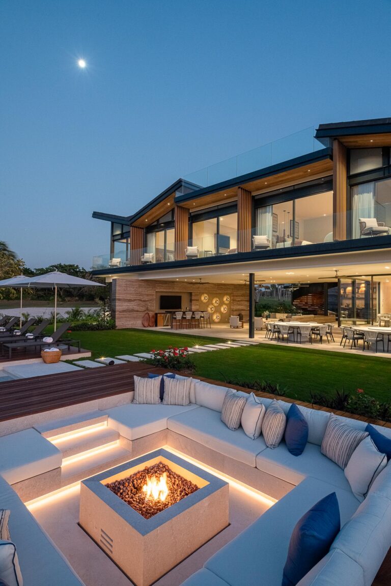 Luxury home in Punta Pacifico, Punta Mita: glass windows, spacious outdoors, sunken seating with fire pit and dining area.