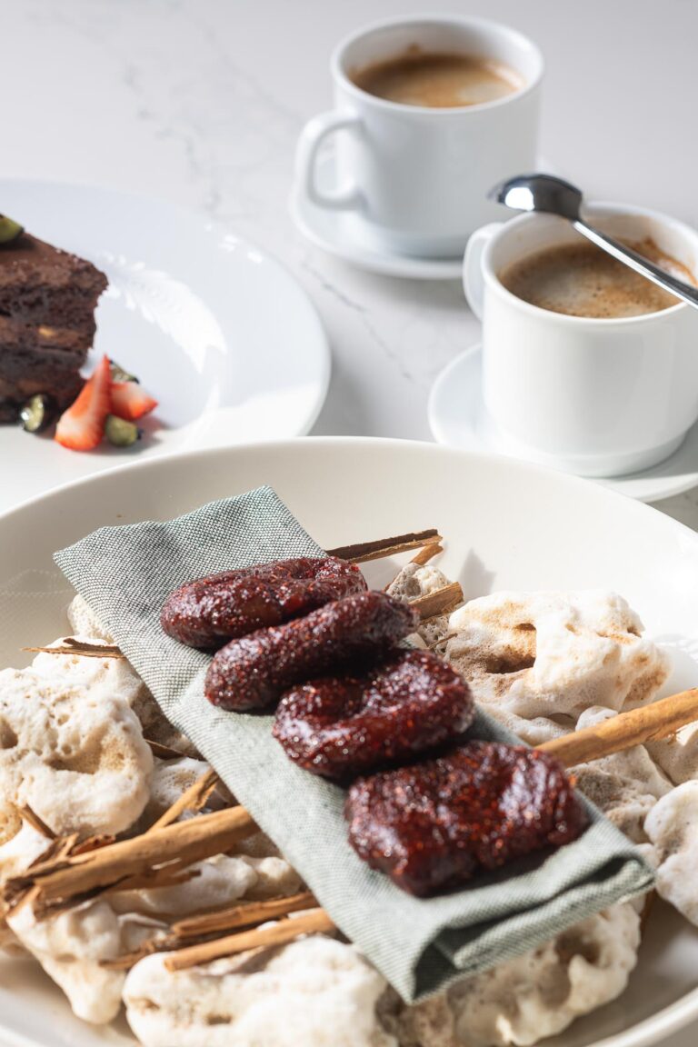 At Punta Pacifico in Punta Mita, cookies and chocolates on a napkin, surrounded by cinnamon sticks and coffee.