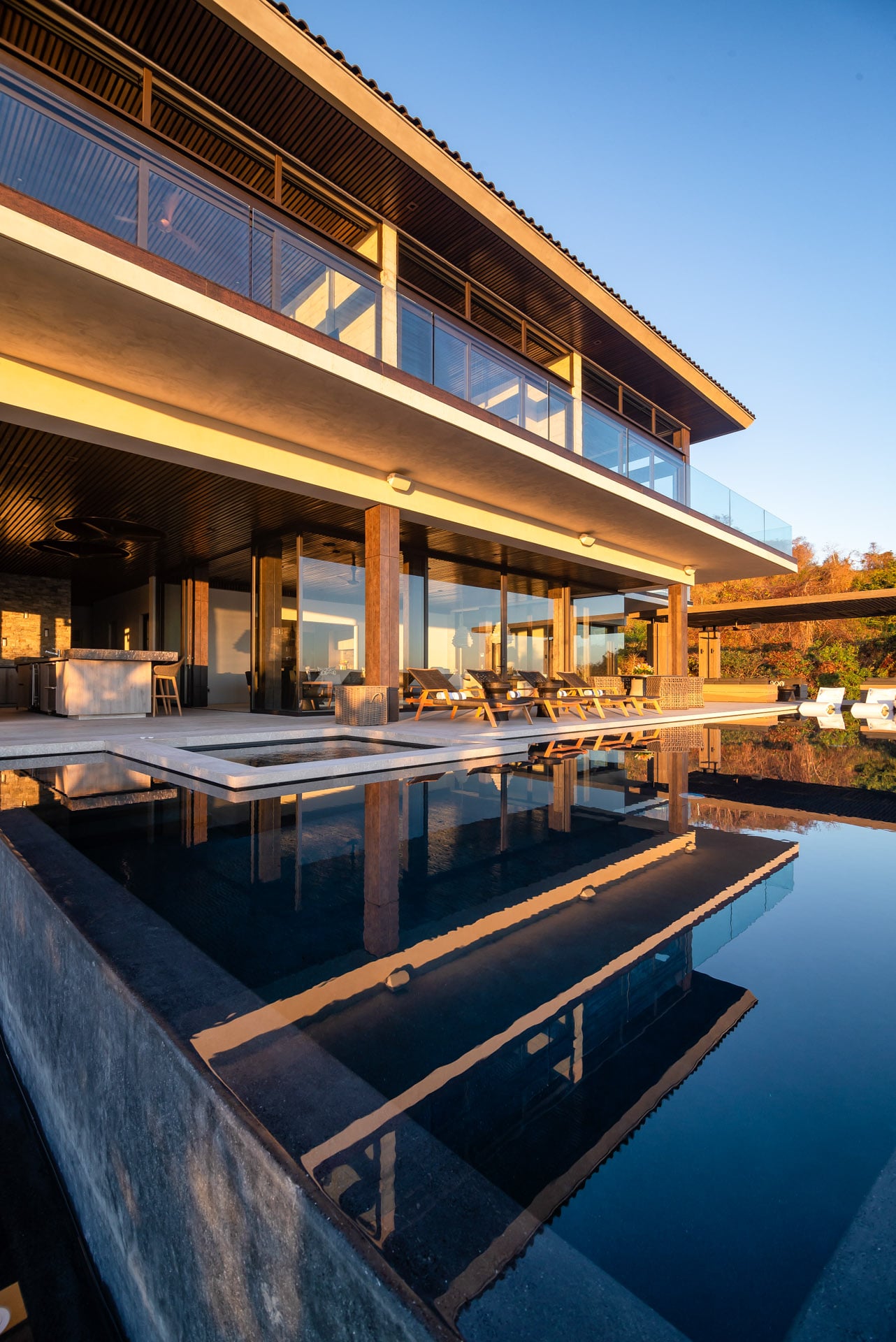 Casa Kupuri 32 the two-storey glass front mirrored in the still pool — Punta Mita, Mexico