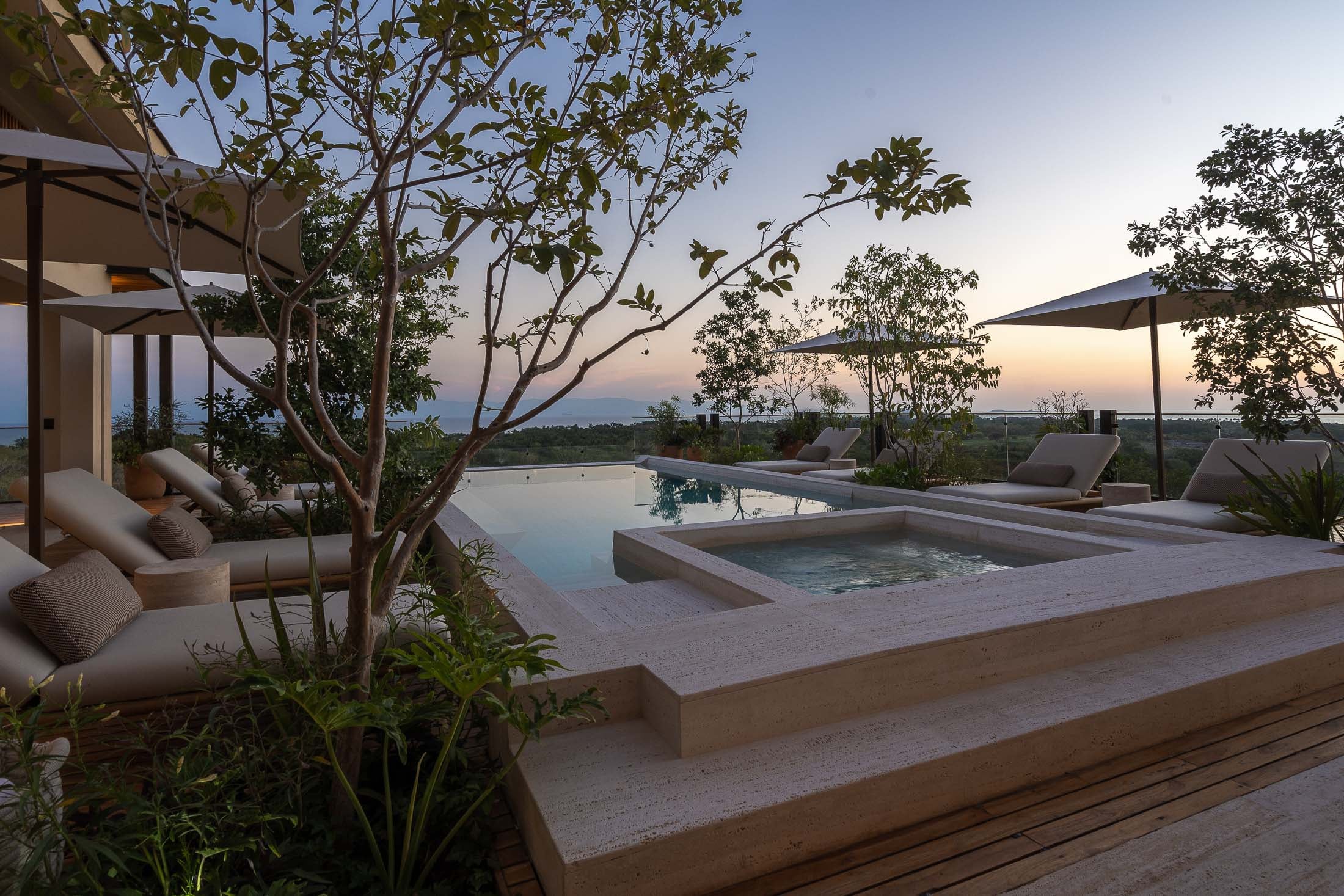 Casa Tuki the raised spa beside the pool with a tree in the foreground at dusk — Punta Mita, Mexico