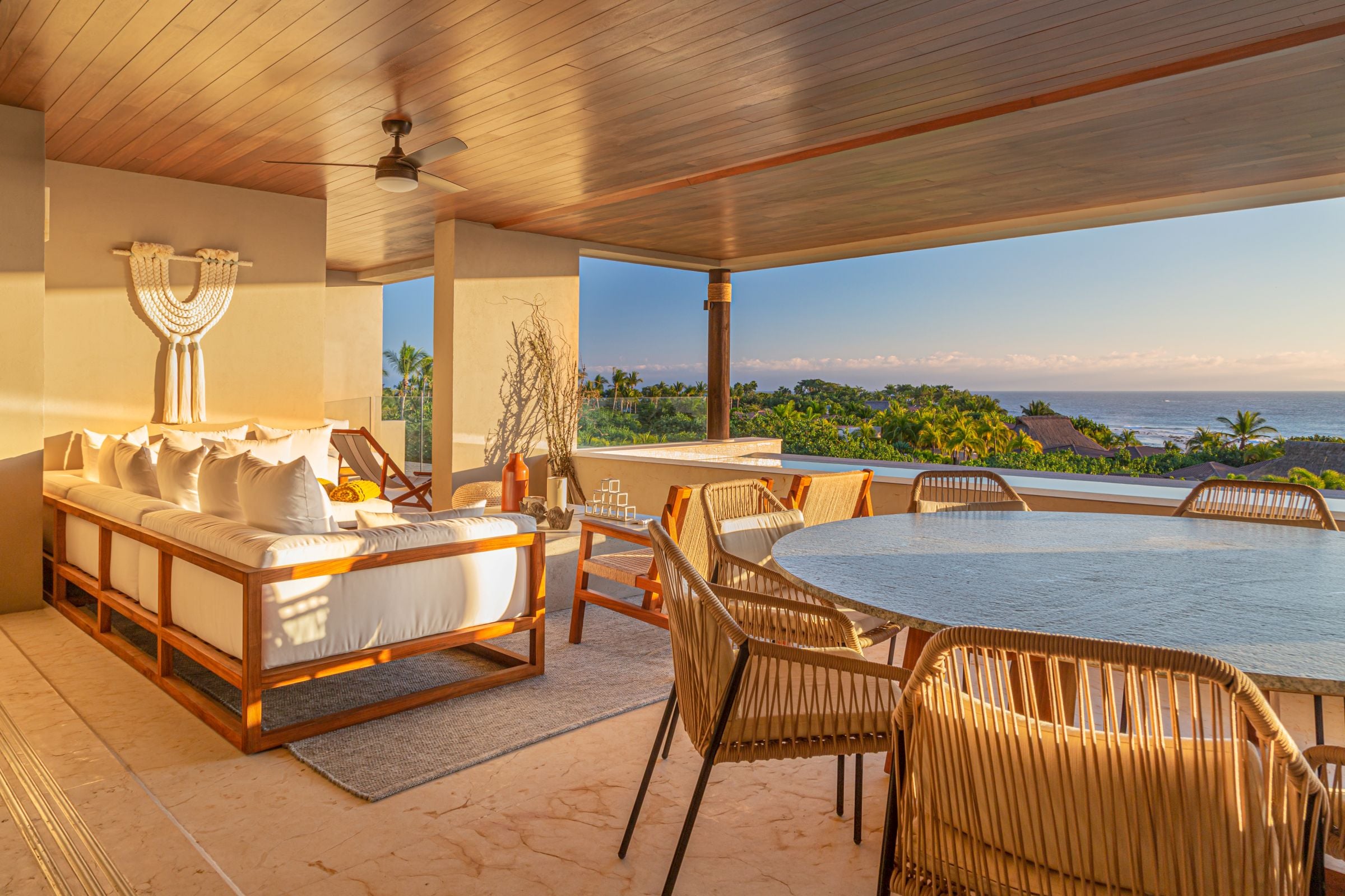 Condo Haramara a canopied daybed and round table on the terrace at sunset — Punta Mita, Mexico