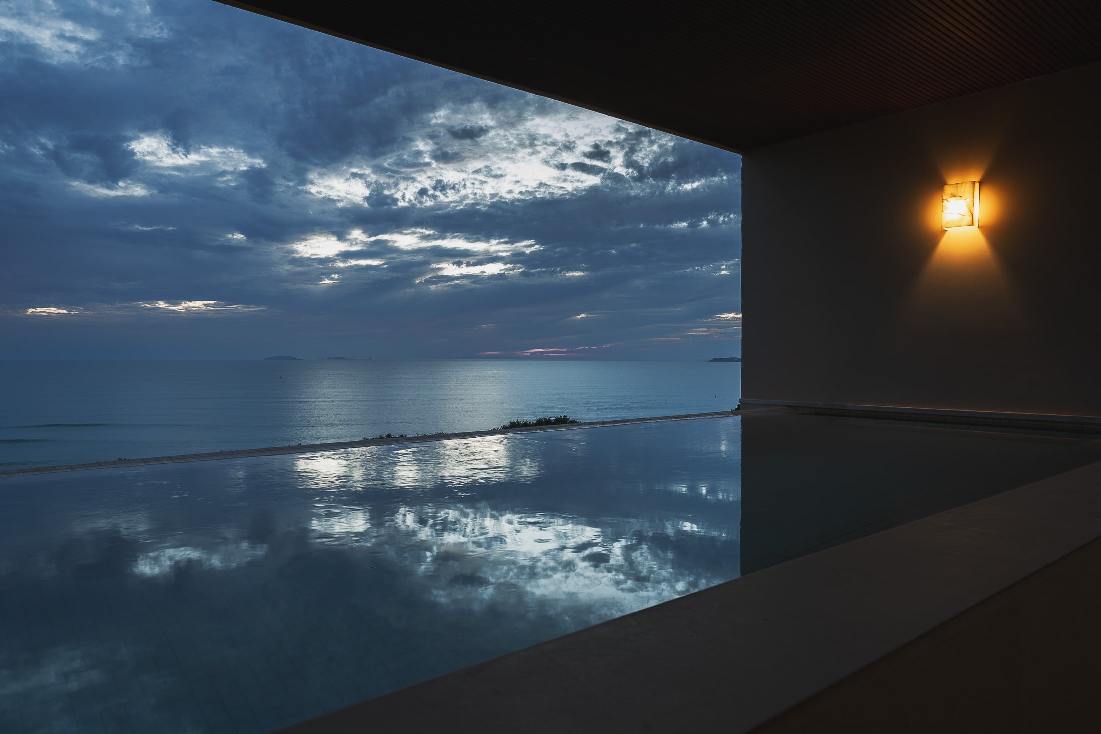 Penthouse ArenaMar the evening sky mirrored in the still rooftop pool — Punta Mita, Mexico