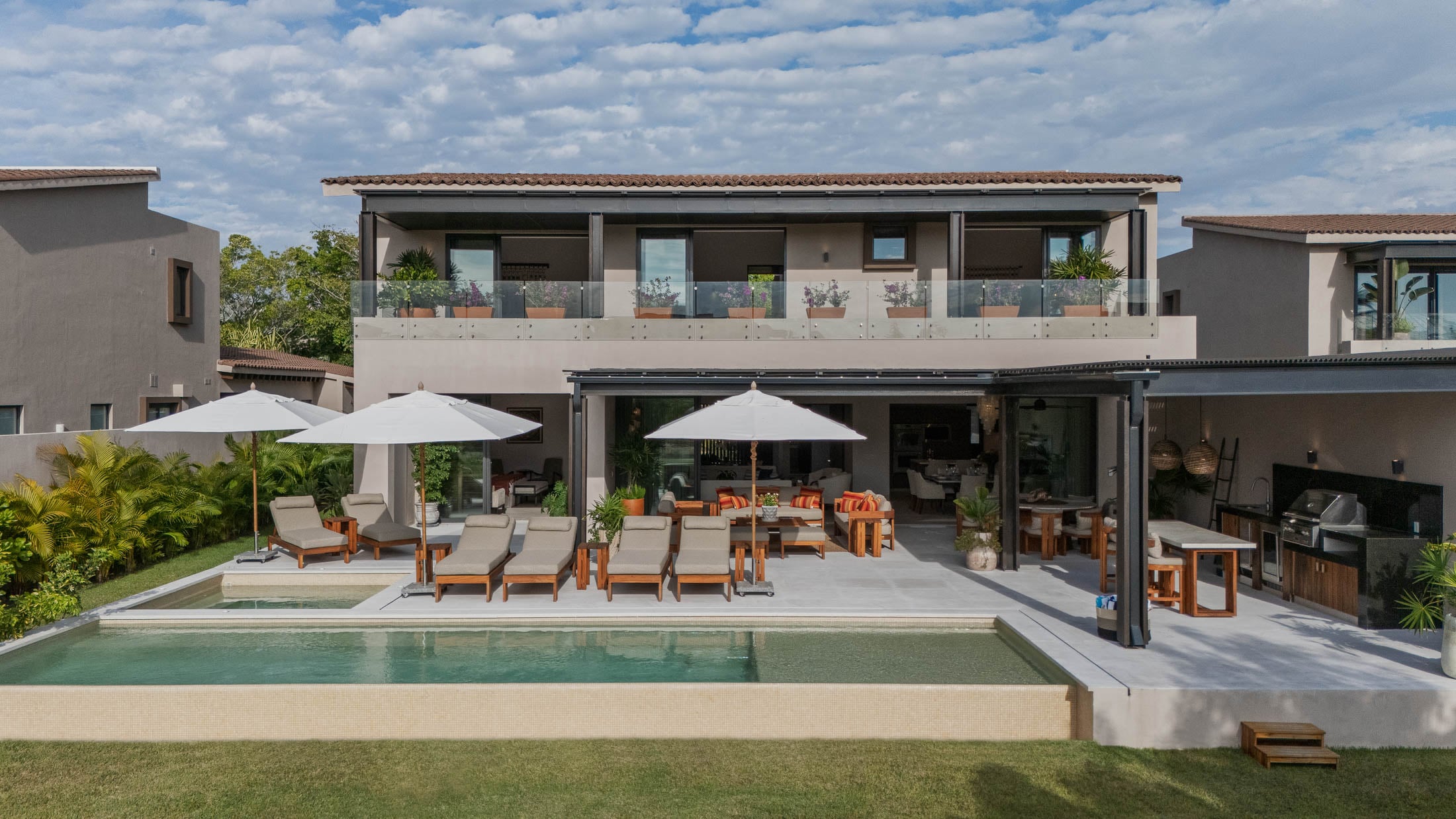 Villa Amada the two-storey rear elevation above the pool and lawn — Punta Mita, Mexico