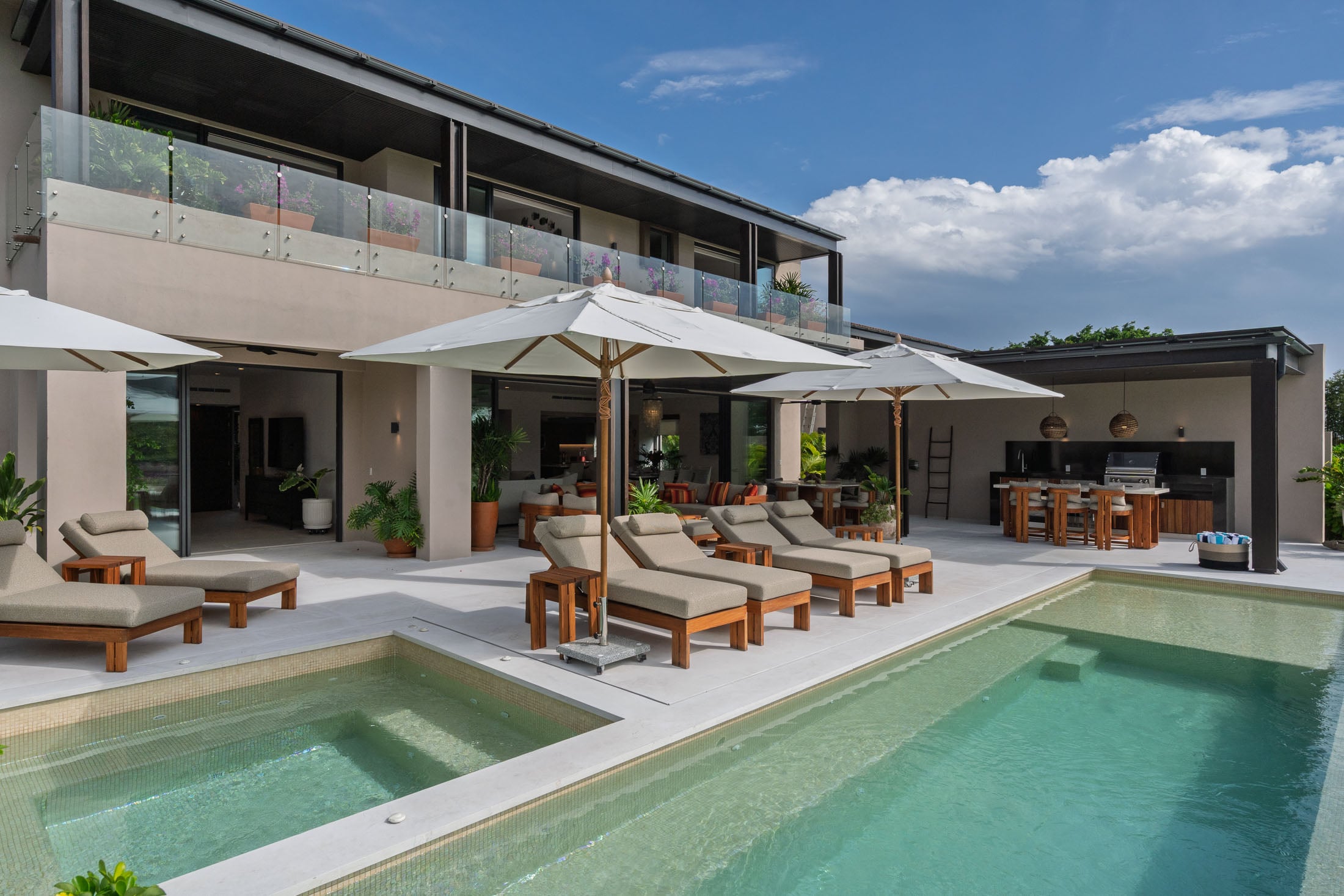Villa Amada the spa alongside the long pool with loungers and umbrellas — Punta Mita, Mexico