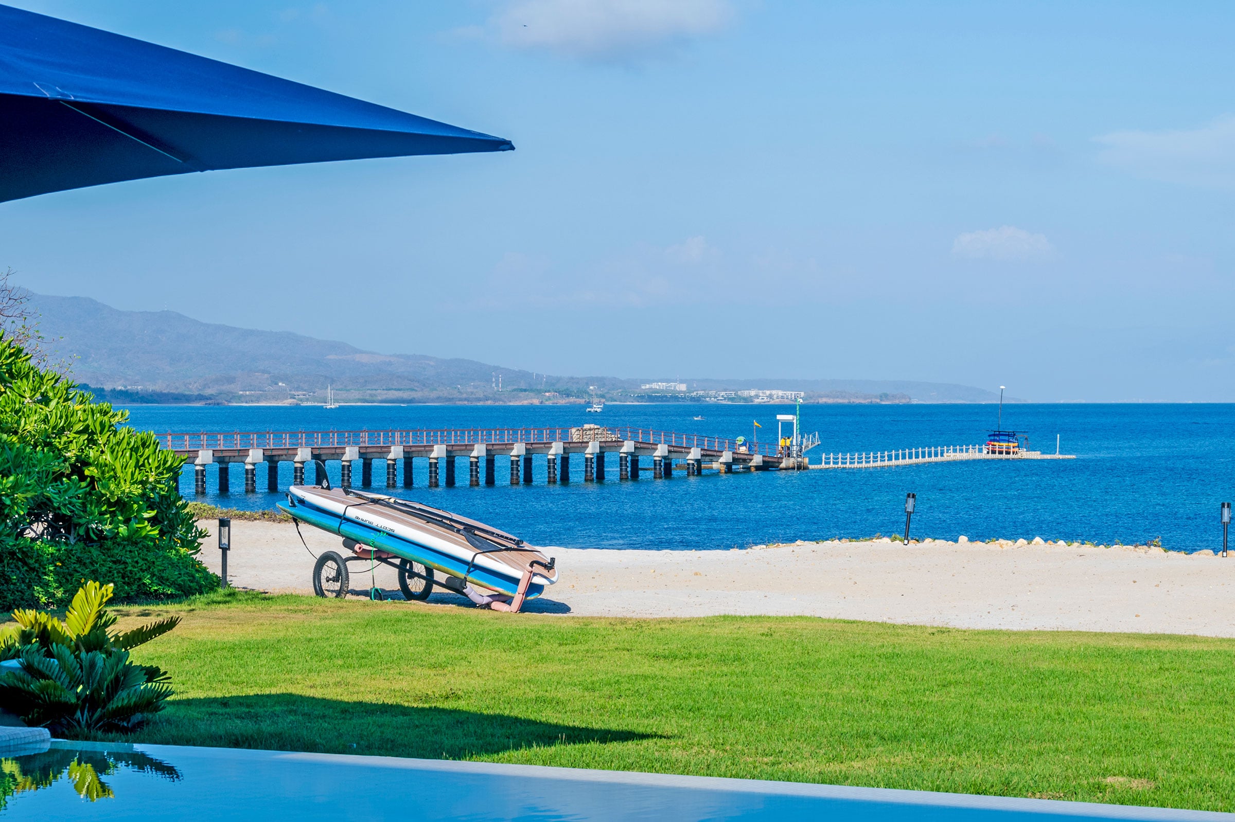 Villa Aurora beachfront lawn with a wooden pier and ocean view — Punta Mita Nayarit, Mexico