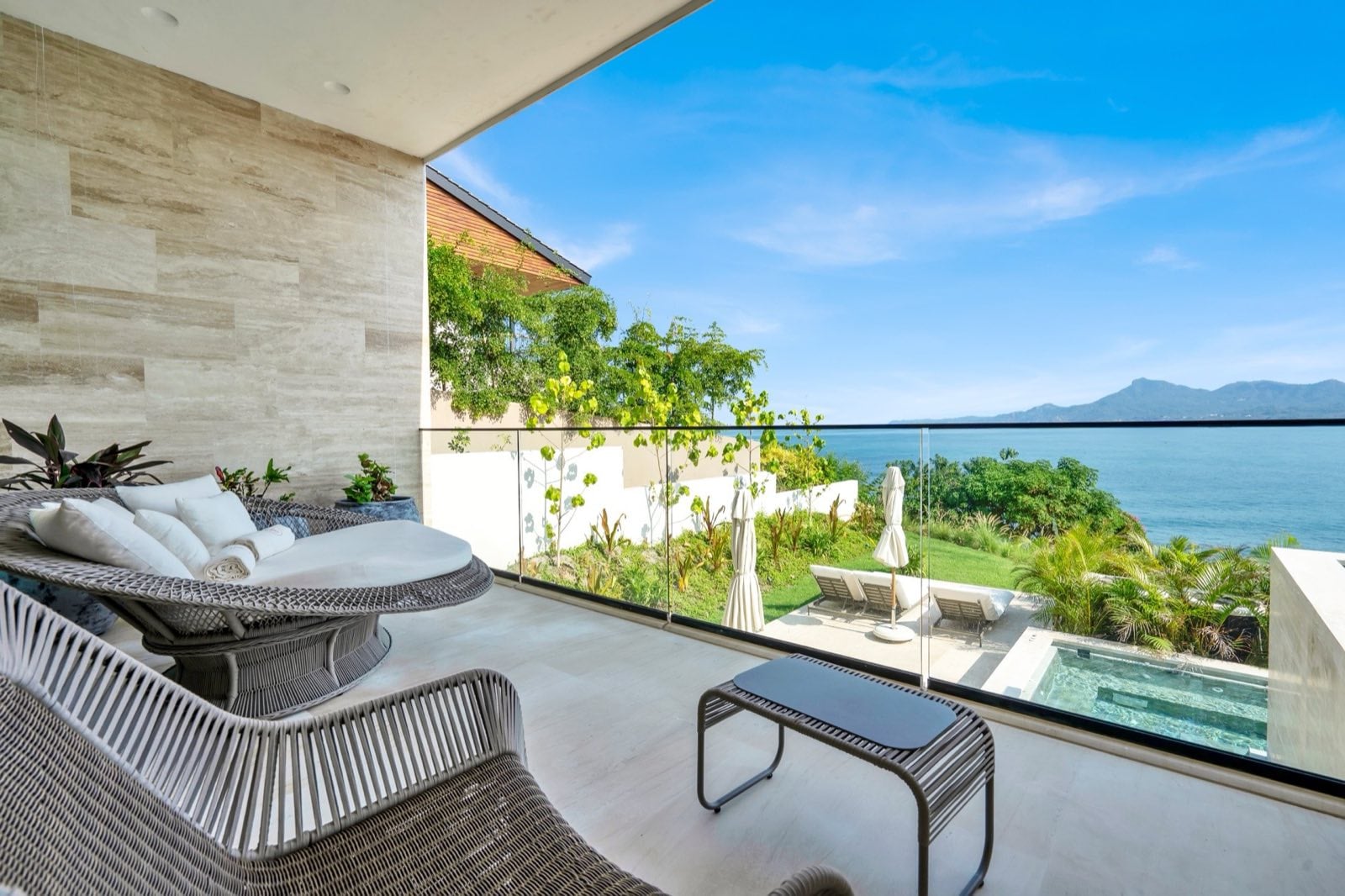 Casa Dinamita balcony with a round woven lounger overlooking the sea and hills — Punta Mita Nayarit, Mexico
