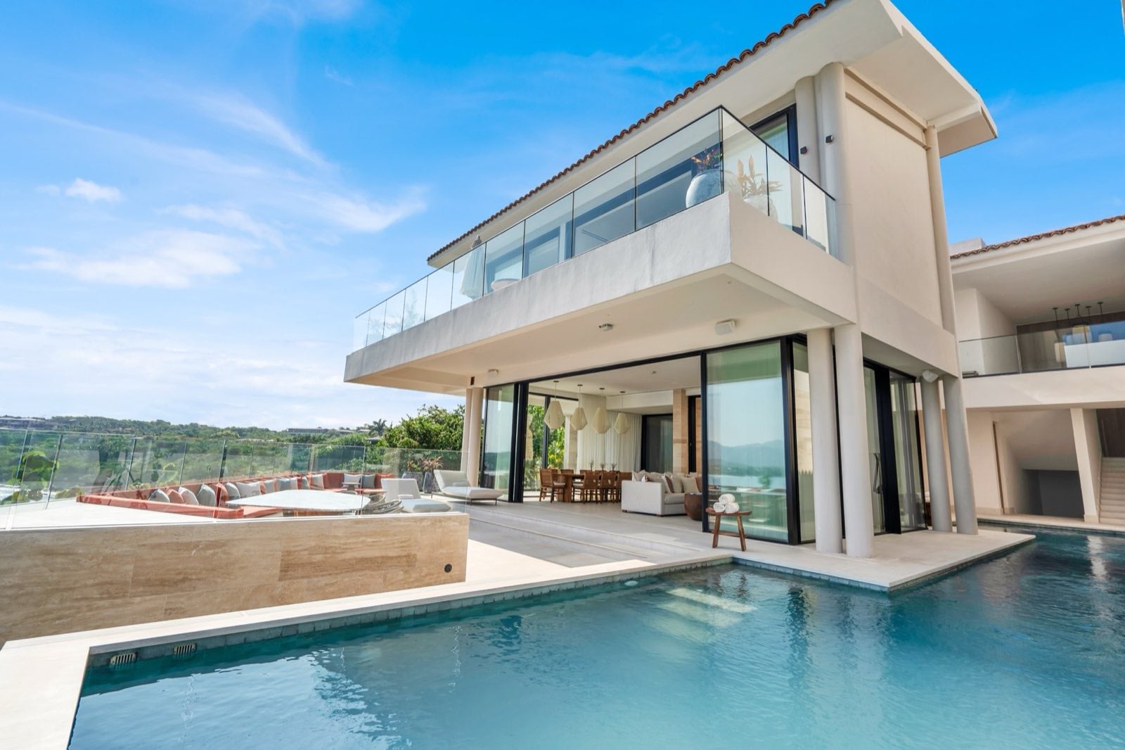 Casa Dinamita villa exterior surrounded by pools below a glass balcony — Punta Mita Nayarit, Mexico