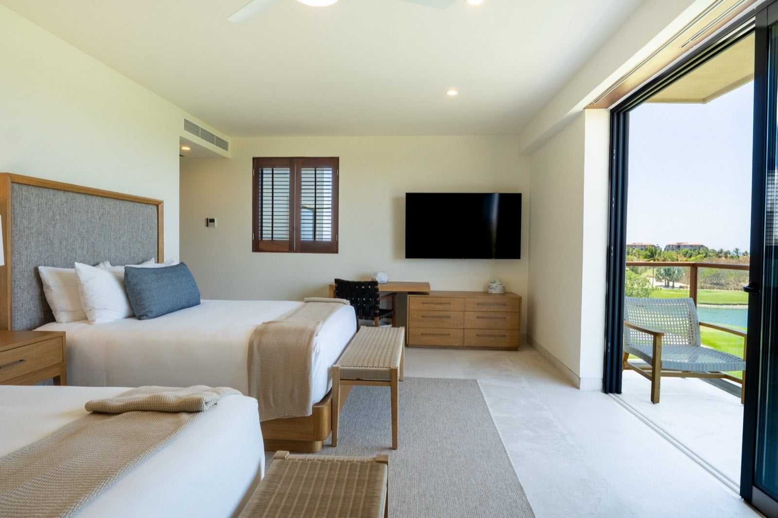 Condo El Encanto 1021 bedroom with two beds, a wall television and open balcony — Punta Mita Nayarit, Mexico