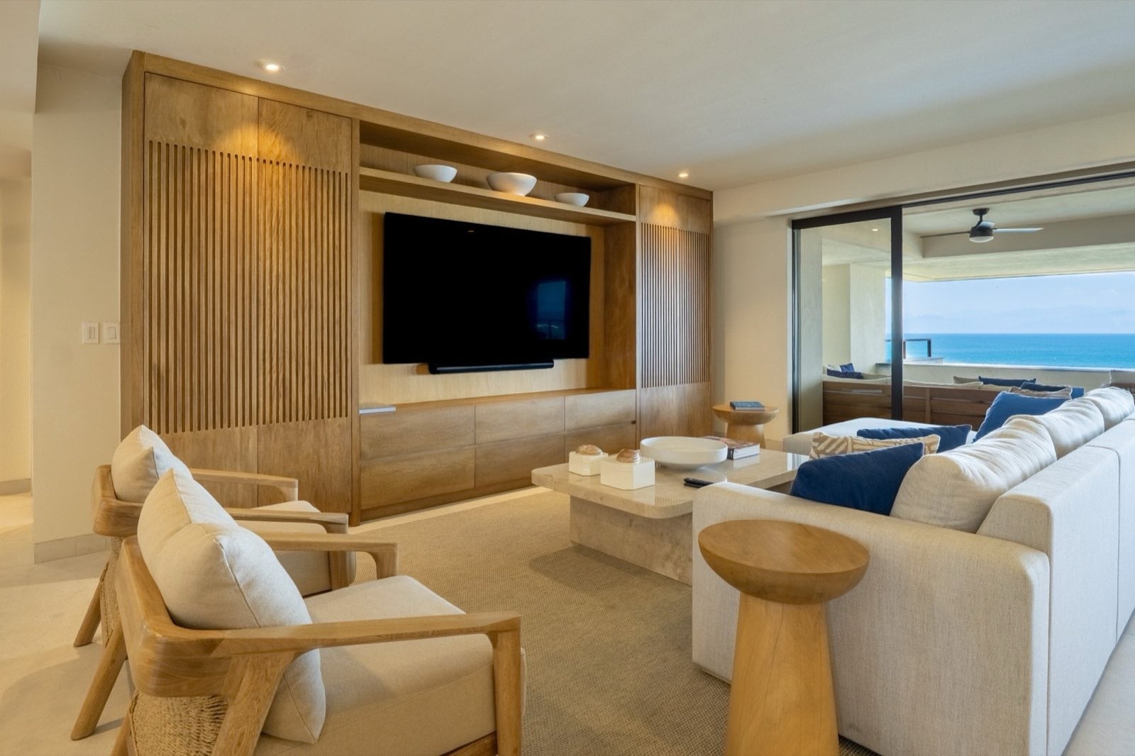 Condo El Encanto 1021 living room with sofas and armchairs facing a wall television — Punta Mita Nayarit, Mexico