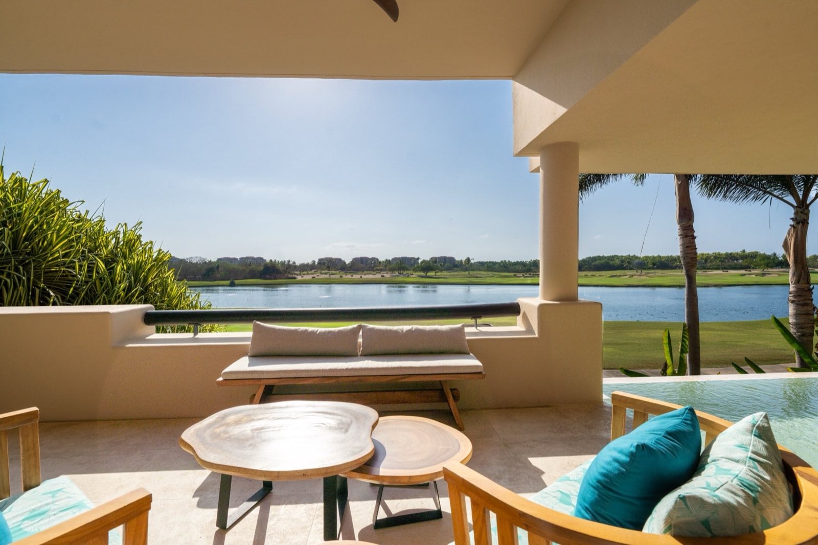 Condo El Encanto 602 terrace seating and two round tables overlooking the lagoon — Punta Mita Nayarit, Mexico