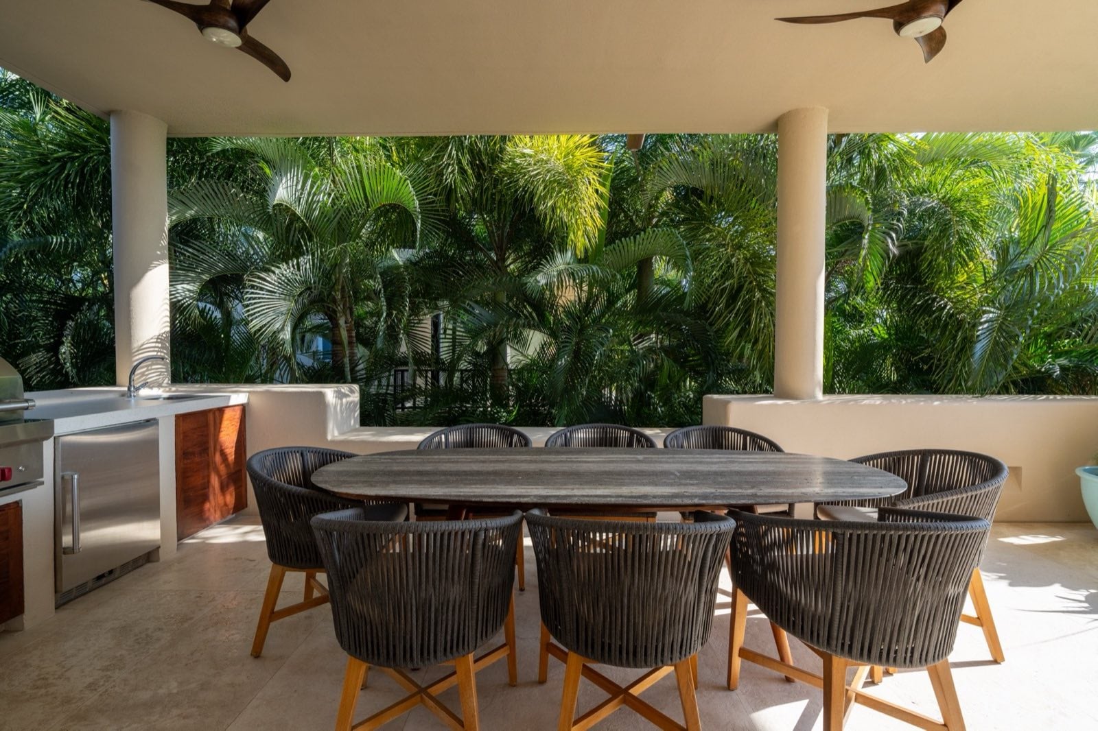 Condo El Encanto 602 covered terrace dining table and chairs beside a grill — Punta Mita Nayarit, Mexico
