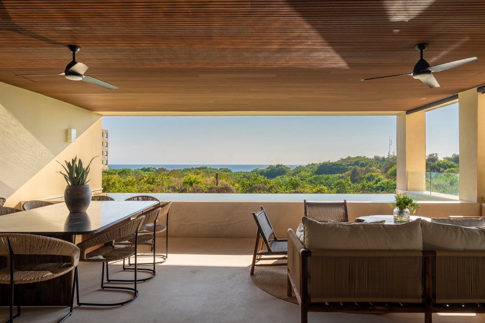 Surf Residences 211 covered terrace with a dining table and treetop view — Punta Mita Nayarit, Mexico