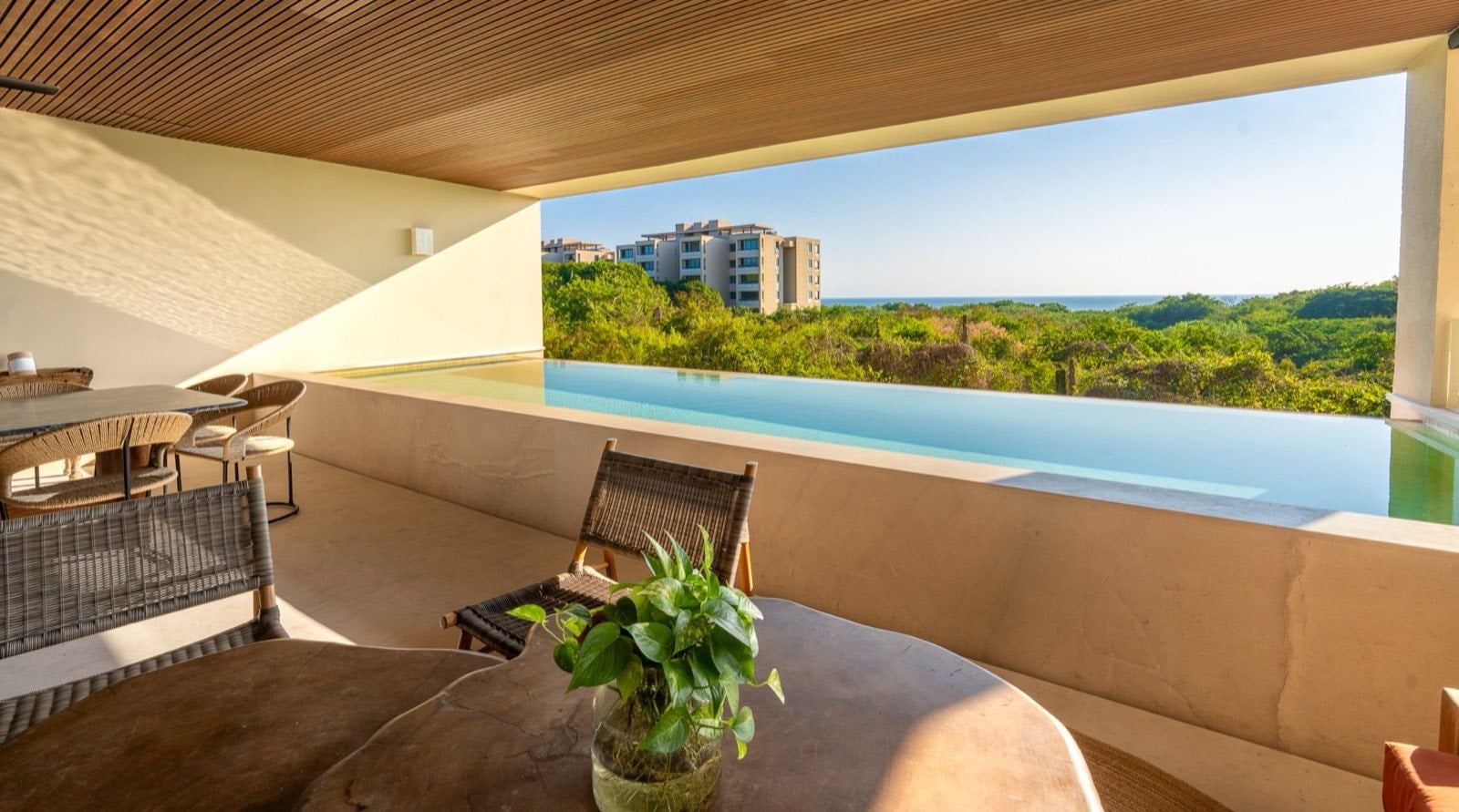 Surf Residences 211 pool terrace with a cushioned lounger and treetop view — Punta Mita Nayarit, Mexico