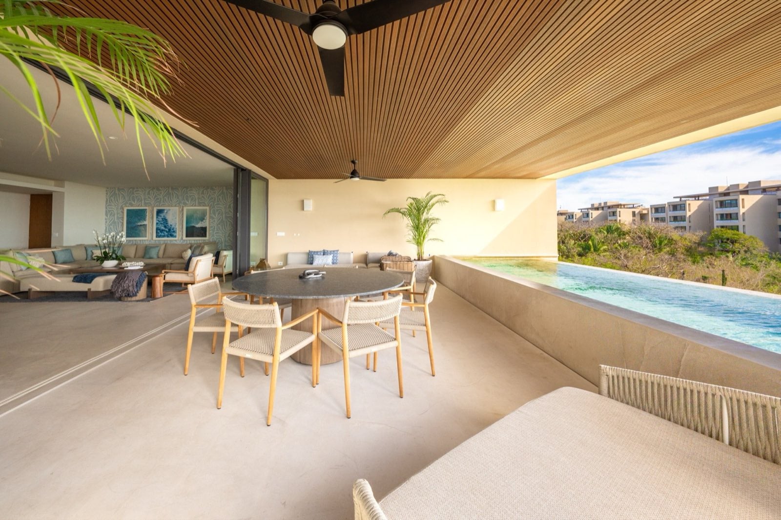 Surf Residences 221 covered terrace with a dining table beside the pool — Punta Mita Nayarit, Mexico