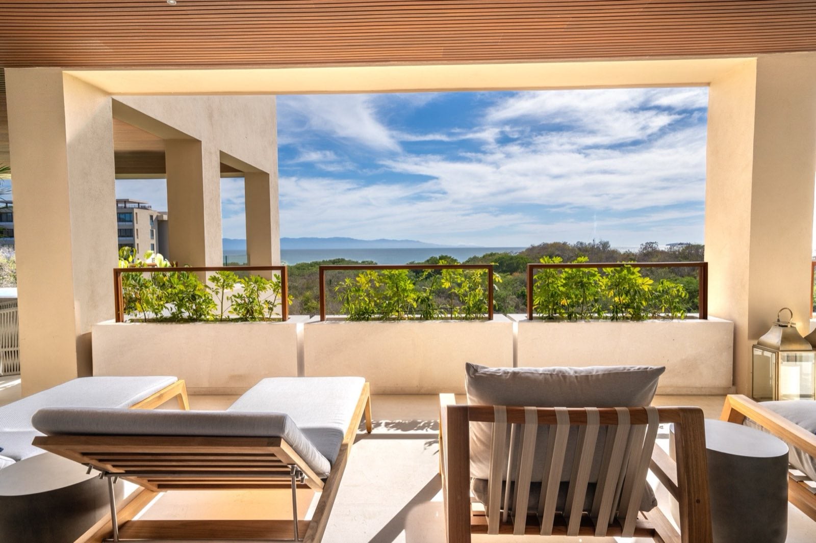 Surf Residences 221 terrace sun loungers overlooking trees and distant water — Punta Mita Nayarit, Mexico