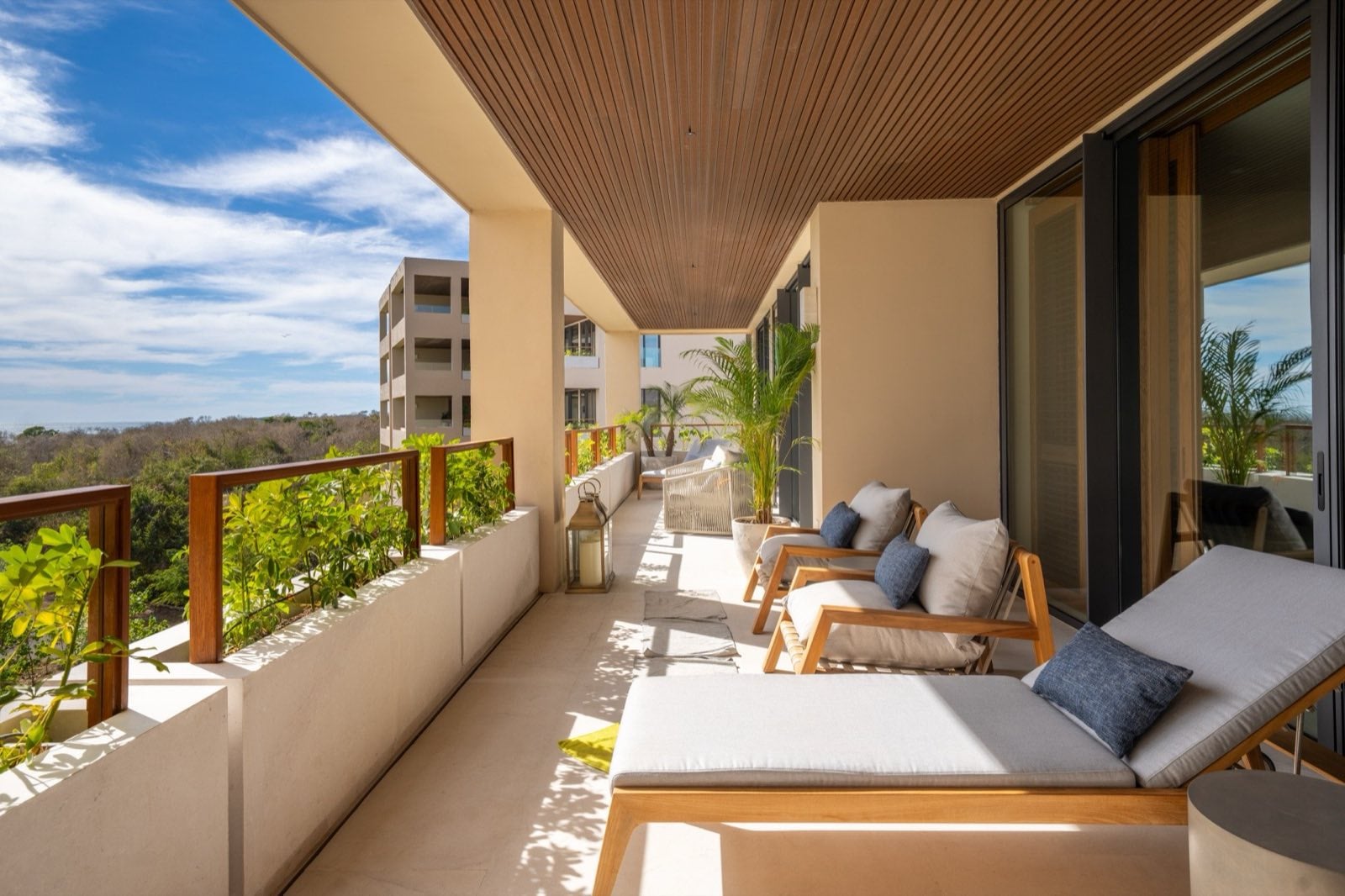 Surf Residences 221 long side terrace with cushioned loungers and a treetop view — Punta Mita Nayarit, Mexico