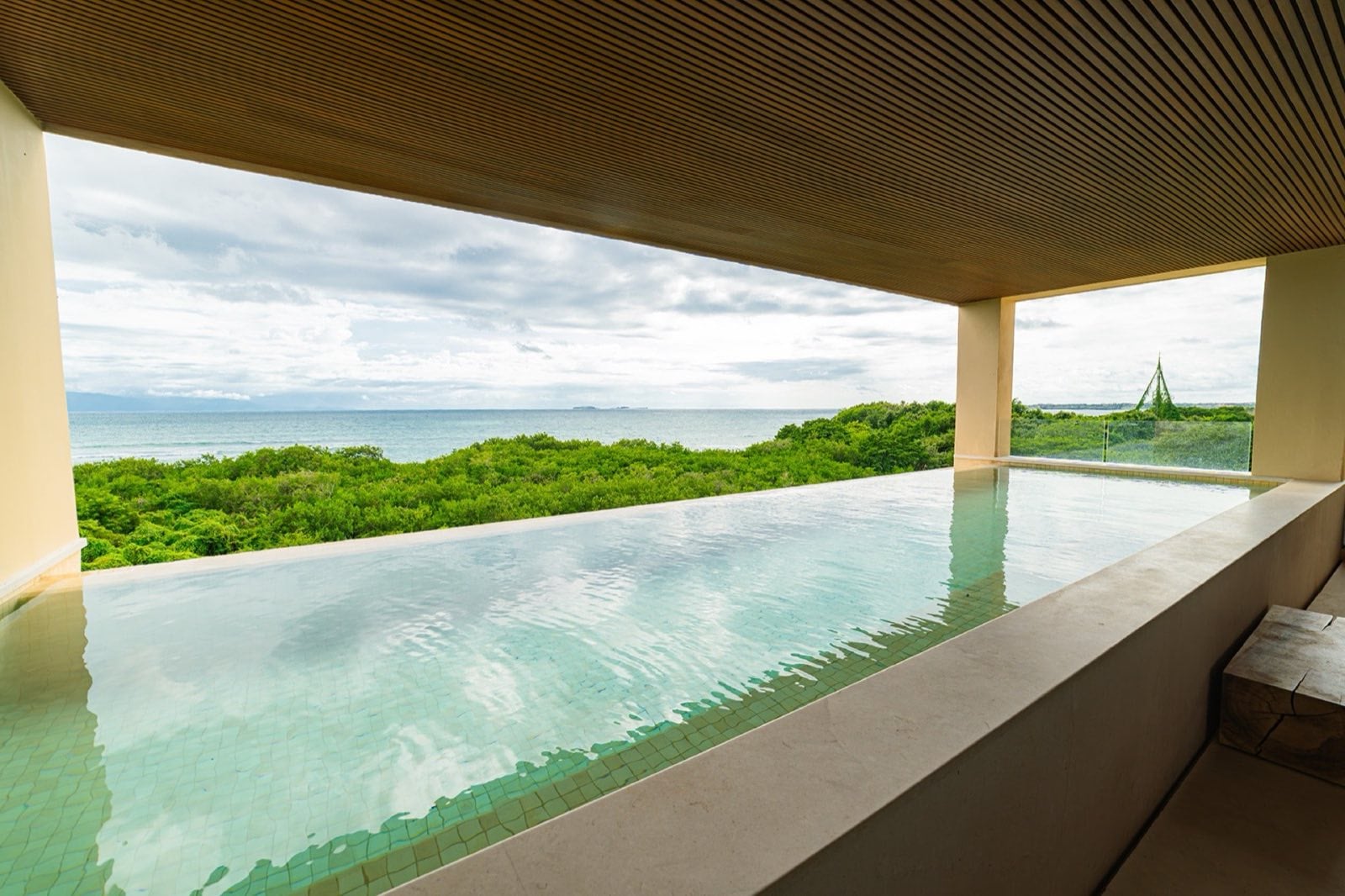 Condo Surf Residences 321 covered pool opening to treetops and ocean — Punta Mita Nayarit, Mexico